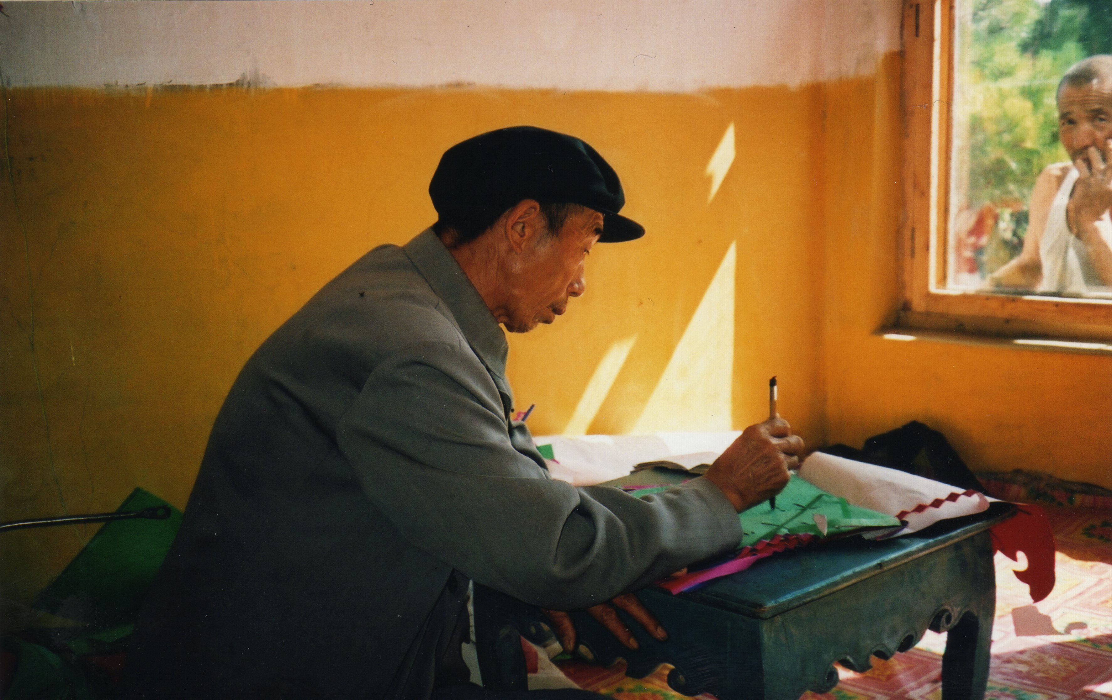 Li Manshan doing ritual paperwork, 2003